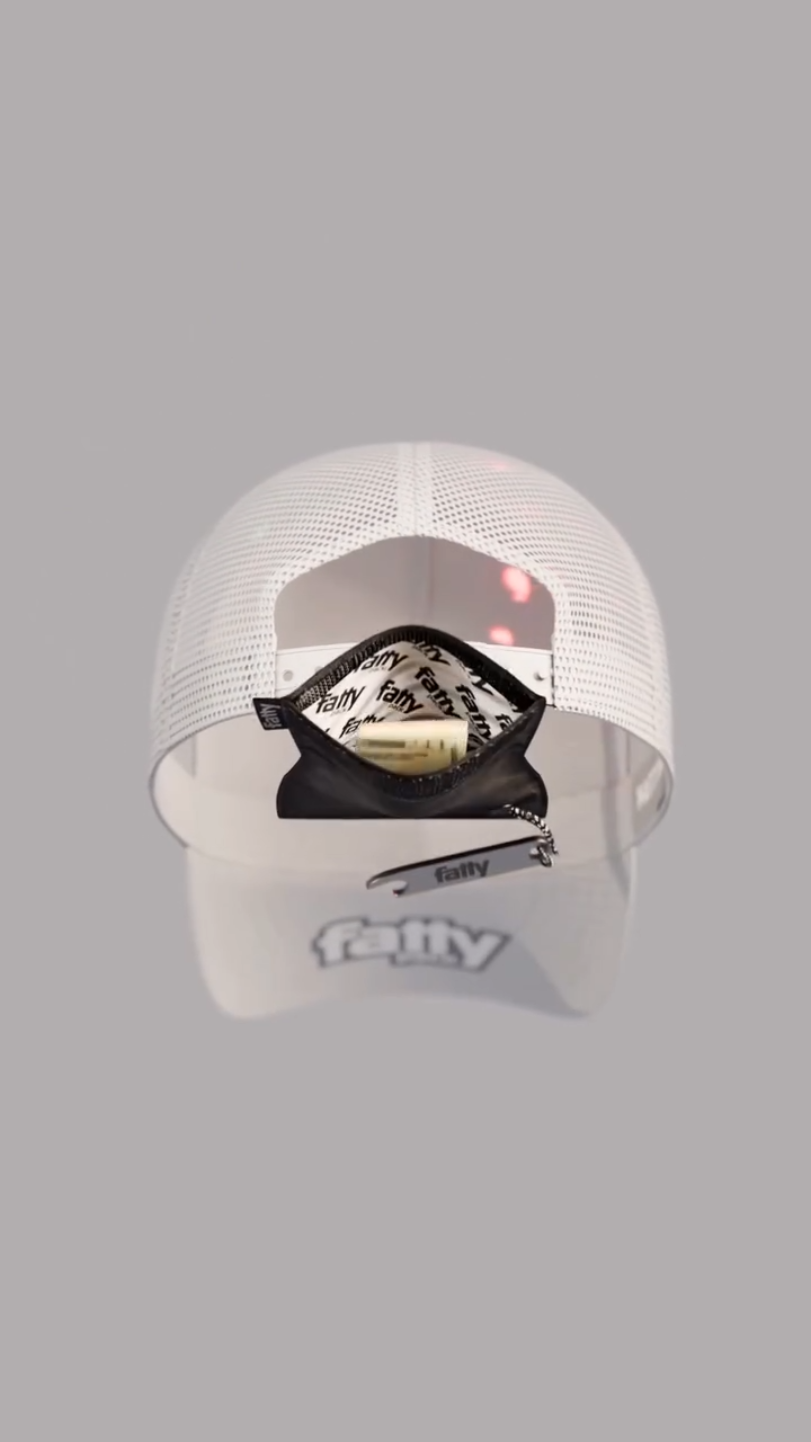 White trucker hat with a FattyPack strapped inside the back