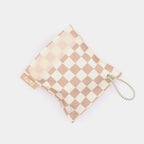 Close-up of the tan checkered FattyPack on a plain background